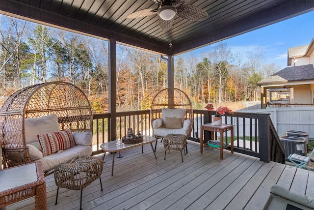 wooden terrace with an outdoor living space, central AC unit, and ceiling fan