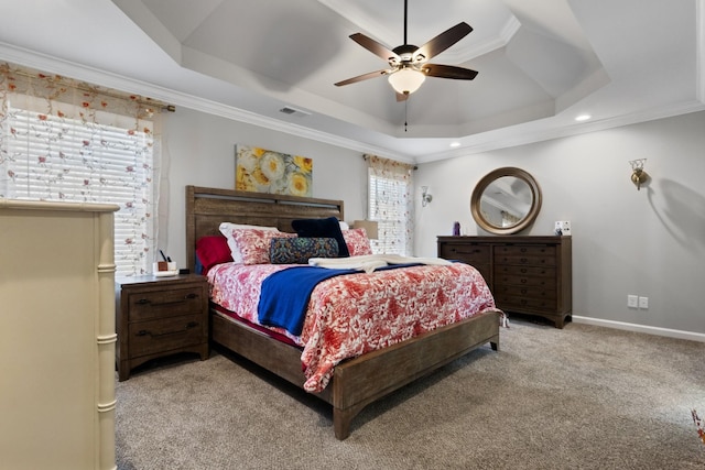 carpeted bedroom featuring crown molding, ceiling fan, and a raised ceiling