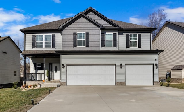 view of property with a garage and covered porch