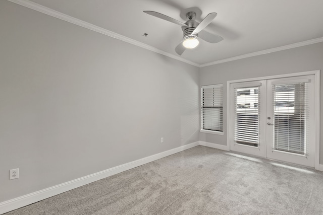 carpeted empty room featuring ceiling fan, ornamental molding, and french doors