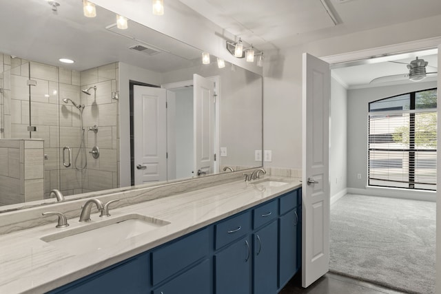 bathroom featuring vanity, ceiling fan, and a shower with shower door