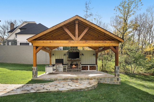 view of patio / terrace featuring a gazebo, grilling area, and an outdoor stone fireplace