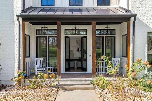 view of exterior entry with covered porch