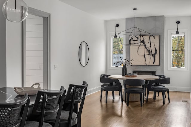 dining space with wood-type flooring