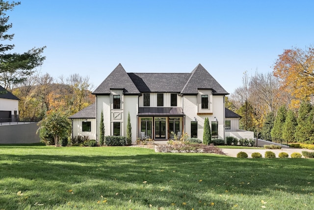 french provincial home with a front yard