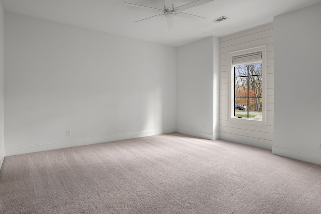 carpeted spare room with ceiling fan