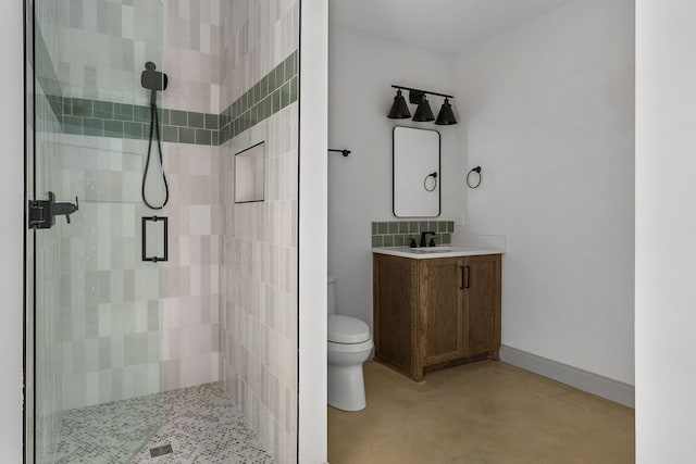 bathroom with vanity, toilet, and a shower with door