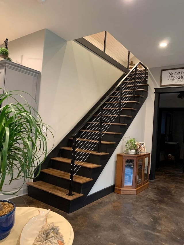 stairway featuring concrete floors