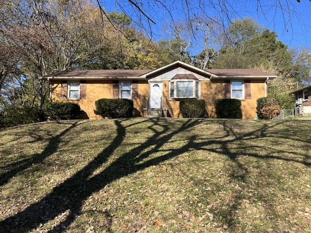 single story home featuring a front lawn