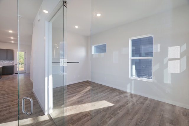 bathroom featuring decorative backsplash and hardwood / wood-style floors