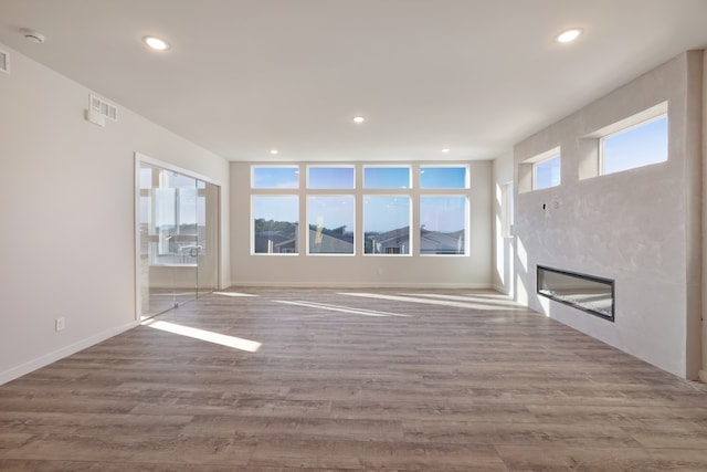 unfurnished living room featuring hardwood / wood-style flooring