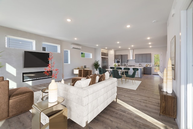 living room with dark hardwood / wood-style flooring and an AC wall unit