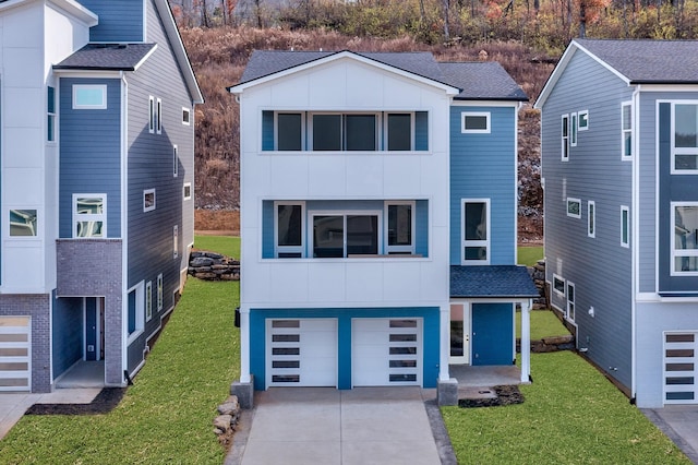 view of front of home with a garage and a front yard