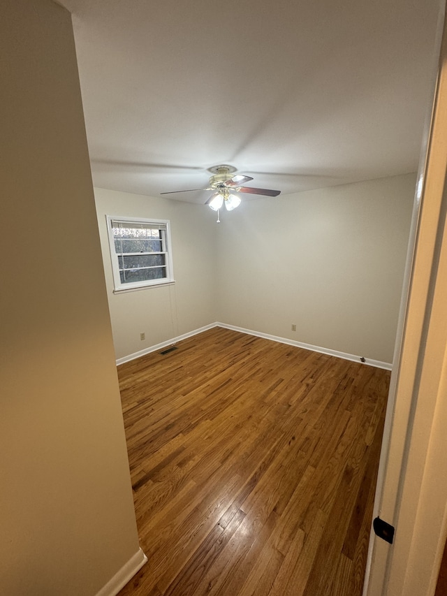 spare room featuring hardwood / wood-style floors and ceiling fan