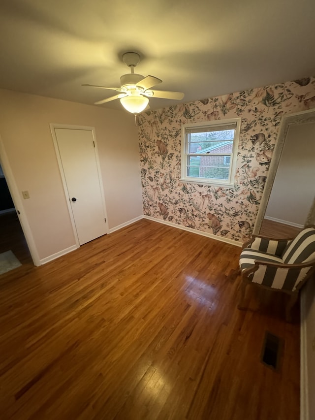 unfurnished bedroom featuring wood-type flooring and ceiling fan