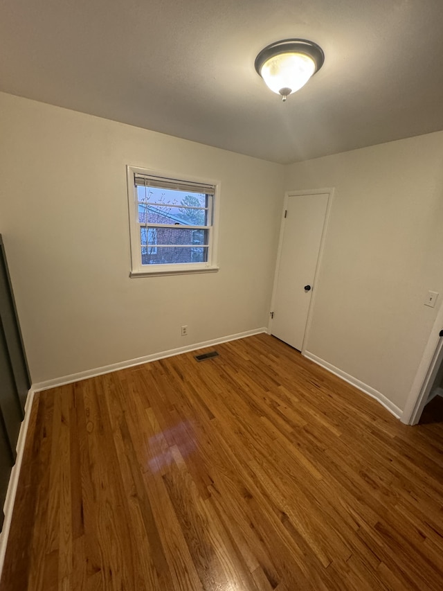 spare room featuring hardwood / wood-style floors