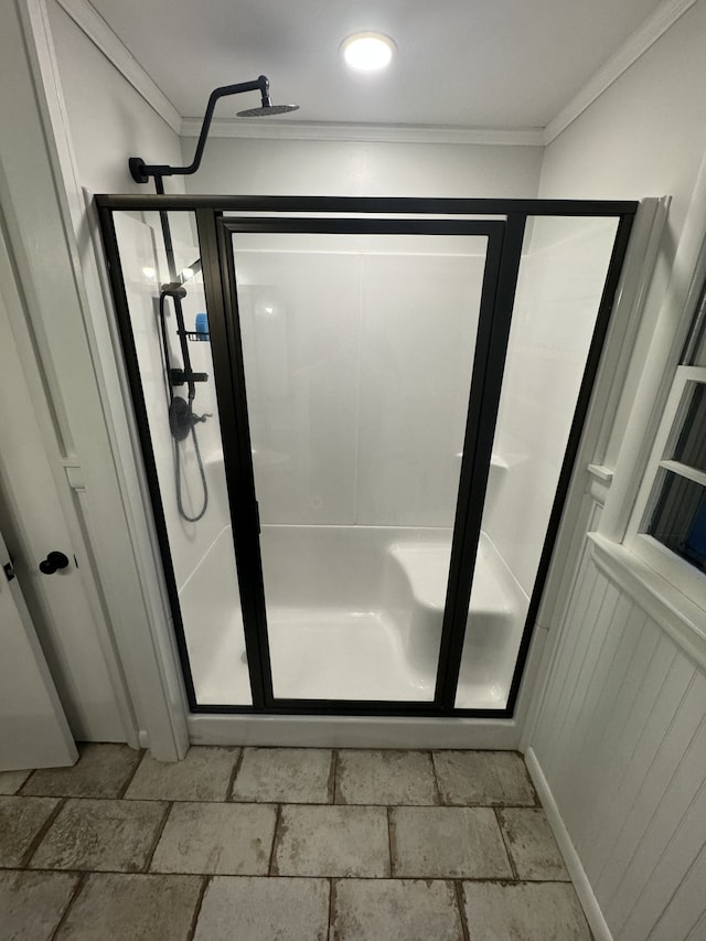 bathroom with crown molding and walk in shower