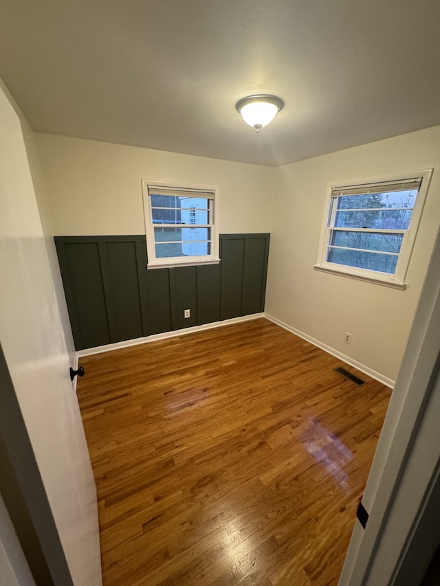 spare room featuring hardwood / wood-style floors