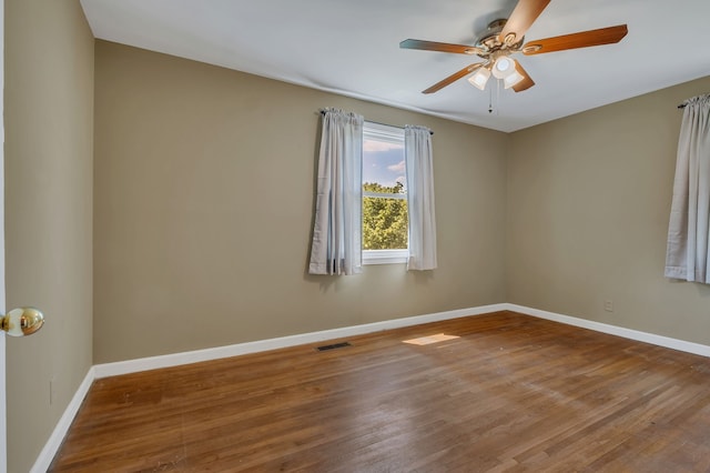 empty room featuring ceiling fan and wood-type flooring