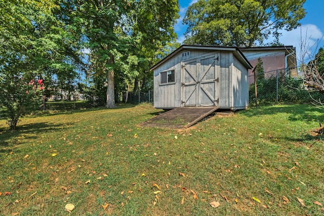 view of outbuilding featuring a yard