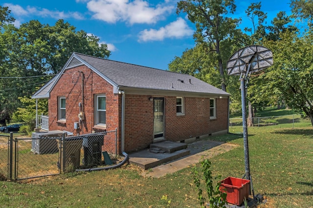 rear view of house with a yard