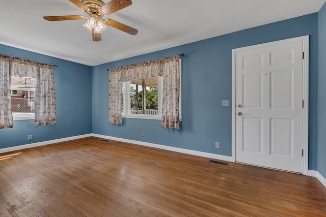 spare room featuring hardwood / wood-style floors and ceiling fan