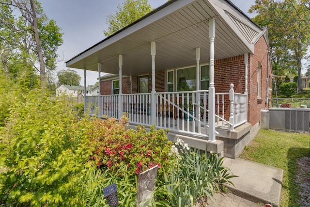 view of side of property with covered porch