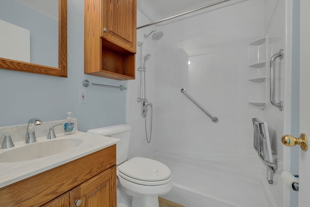 bathroom with a shower, vanity, and toilet