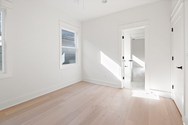 unfurnished room with light wood-type flooring