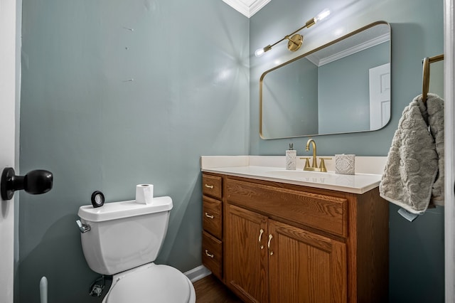 bathroom featuring crown molding, vanity, and toilet