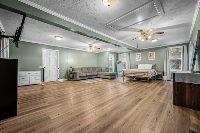 bedroom with hardwood / wood-style flooring, ornamental molding, and a textured ceiling