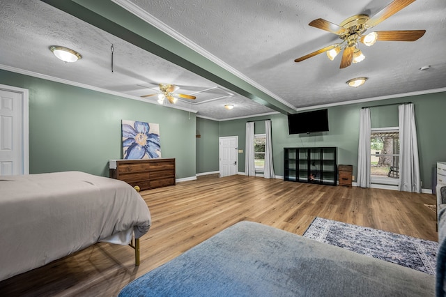 bedroom featuring crown molding, hardwood / wood-style floors, ceiling fan, and a textured ceiling