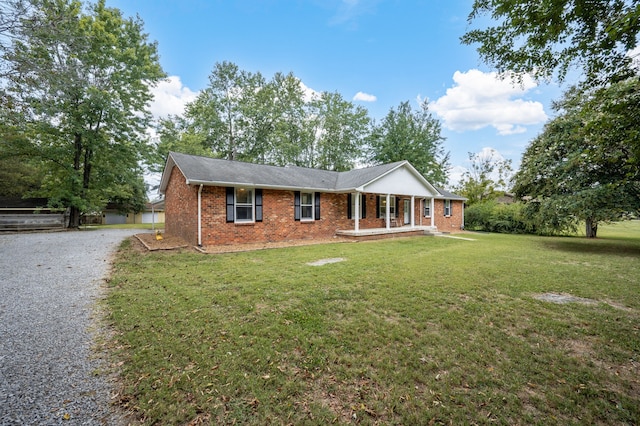 single story home with covered porch and a front yard