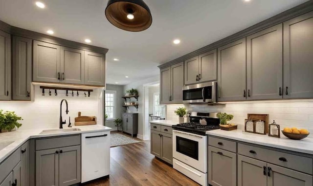 kitchen with gray cabinets, tasteful backsplash, appliances with stainless steel finishes, and sink