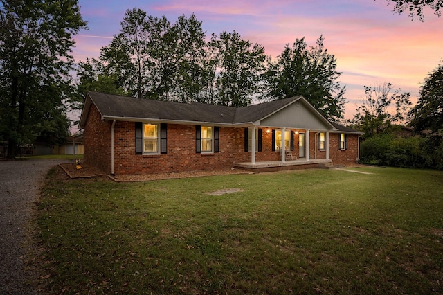 view of front facade featuring a yard and covered porch