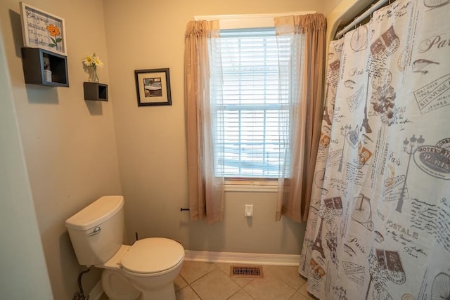 bathroom with tile patterned flooring and toilet