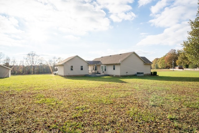 rear view of property featuring a yard