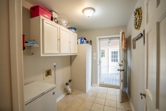 clothes washing area with cabinets, hookup for a washing machine, and light tile patterned floors