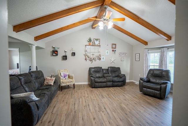 living room with ceiling fan, lofted ceiling with beams, decorative columns, light hardwood / wood-style floors, and a textured ceiling