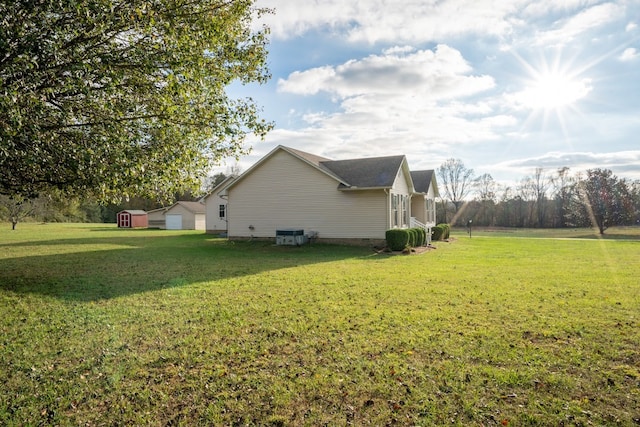 view of home's exterior featuring an outbuilding, a shed, crawl space, and a lawn