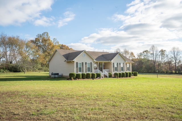 ranch-style home featuring a porch, a front yard, and cooling unit