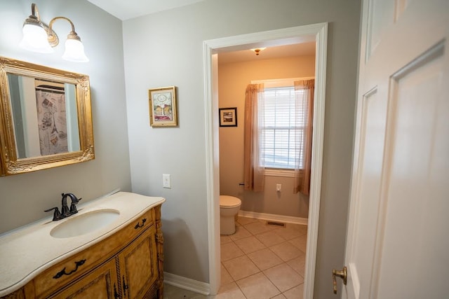 bathroom featuring tile patterned floors, vanity, and toilet