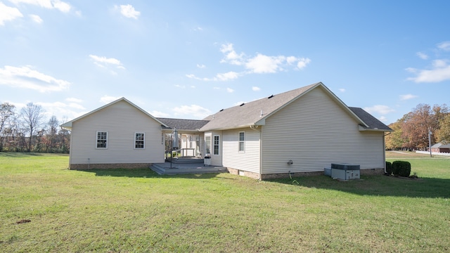 rear view of house with a deck and a yard