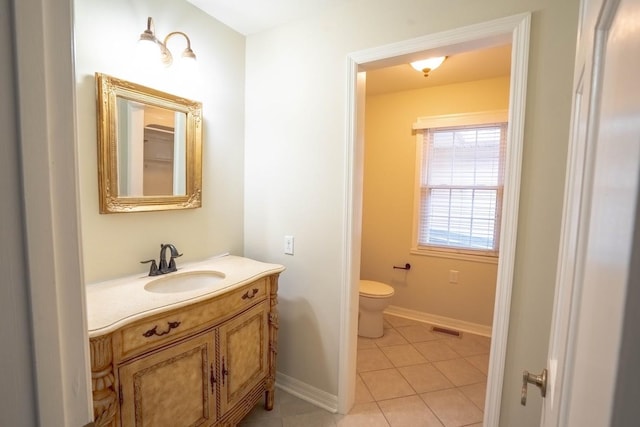 bathroom featuring baseboards, visible vents, toilet, tile patterned floors, and vanity