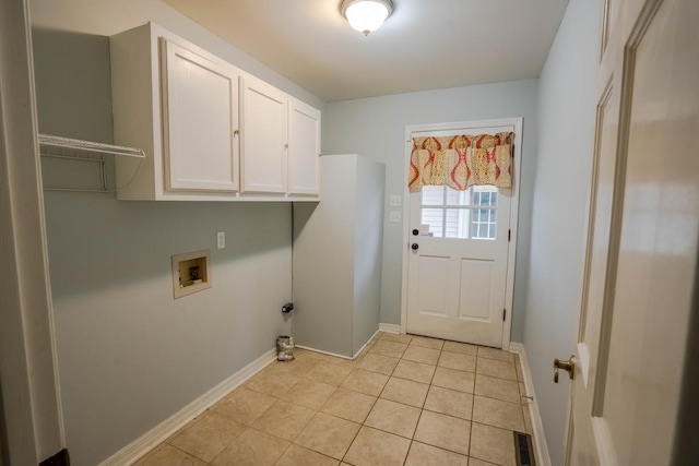 clothes washing area with light tile patterned flooring, washer hookup, visible vents, baseboards, and cabinet space