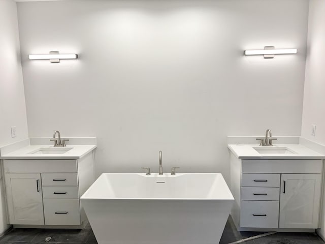 bathroom featuring a sink, a soaking tub, and two vanities