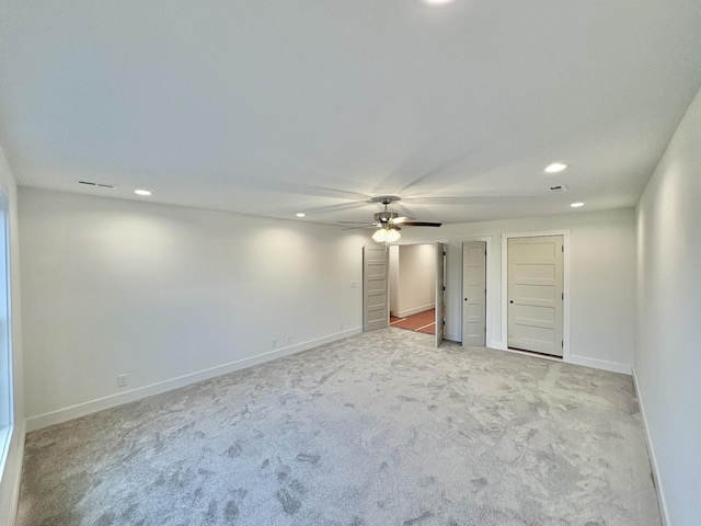 unfurnished room with recessed lighting, light carpet, visible vents, a ceiling fan, and baseboards