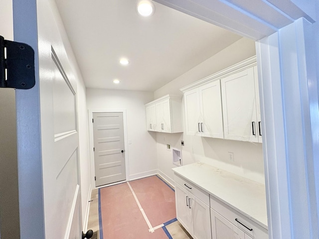 clothes washing area with recessed lighting, cabinet space, electric dryer hookup, and baseboards