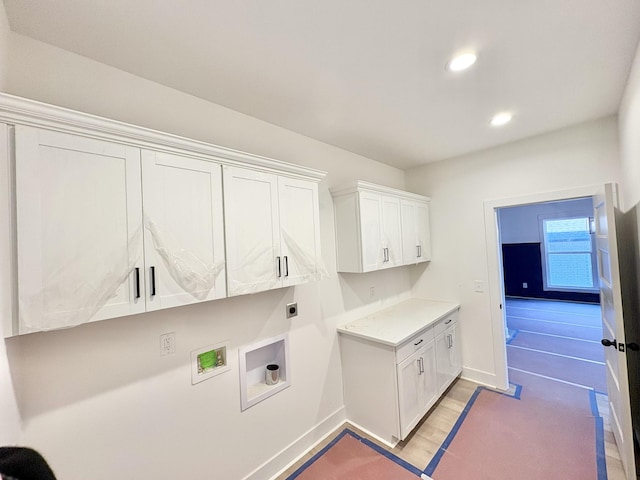 washroom with washer hookup, recessed lighting, cabinet space, hookup for an electric dryer, and baseboards