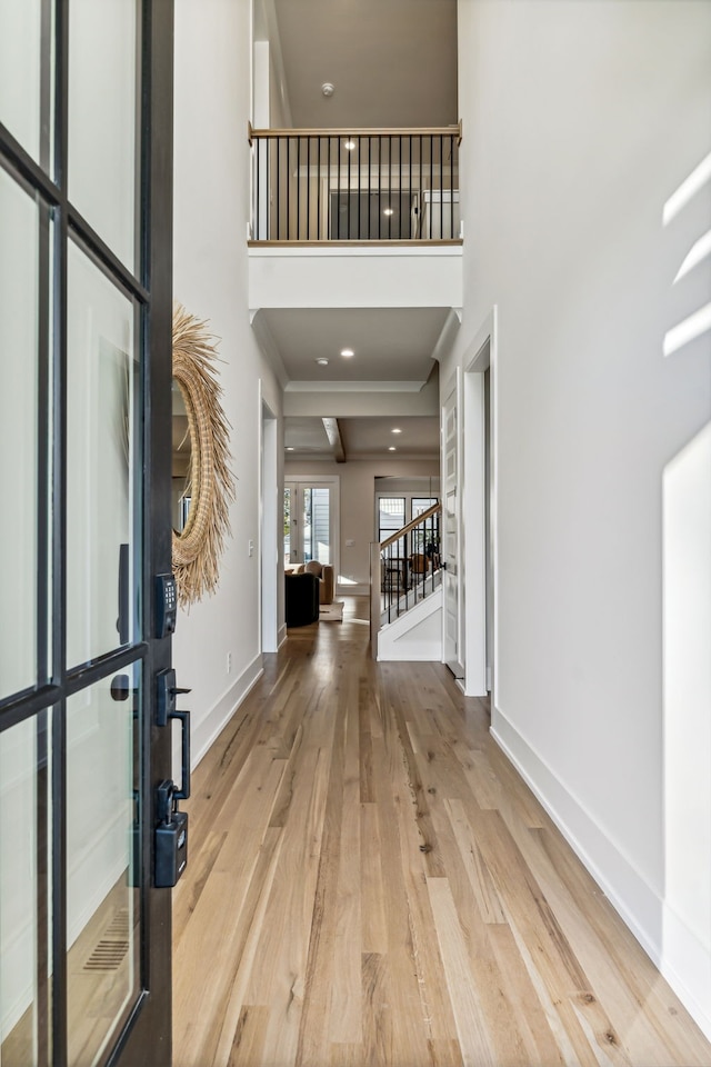 entryway featuring light hardwood / wood-style flooring and a high ceiling